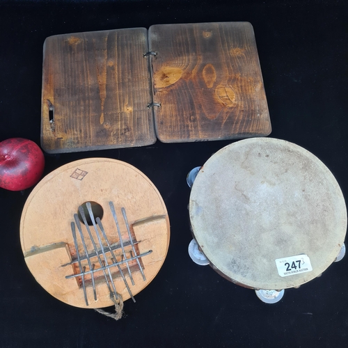 247 - Three items of musical interest including an African thumb piano crafted from a coconut, a tambourin... 