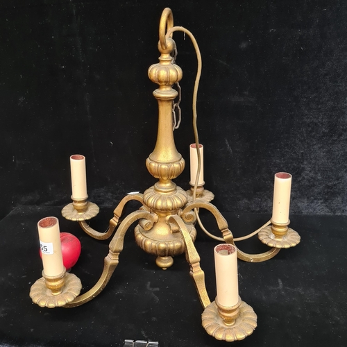 255 - An ornate brass five branch candelabra, featuring elegant scrollwork throughout.