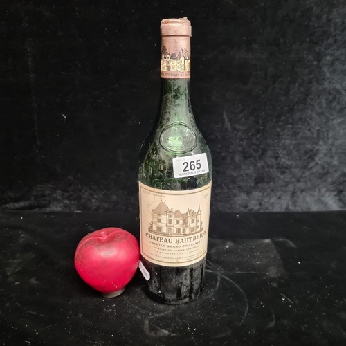 265 - An opened half full bottle of vintage Château Haut-Brion wine, showcasing a rich history and anticip... 