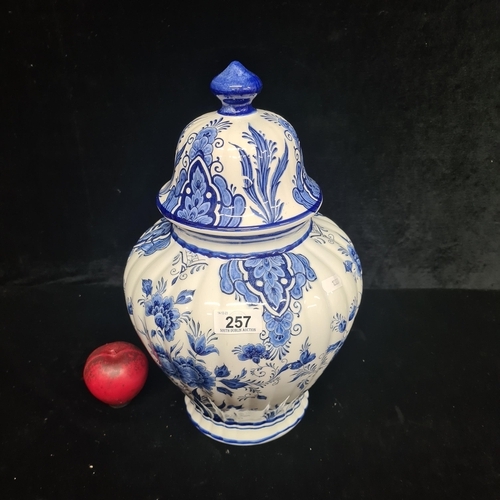 257 - An elegant large Danish covered jar, evoking a classic style with cobalt blue floral motifs on white... 