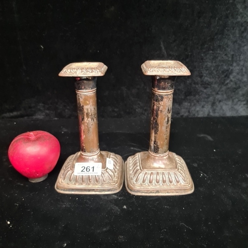 261 - A pair of patinated dwarf candlesticks, showcasing neoclassical motifs. An evocative touch of histor... 