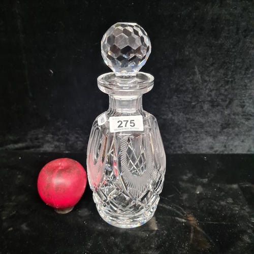 A fabulous Waterford Crystal decanter featuring intricate cuts and original stopper. tiny teeny nibble to rim.