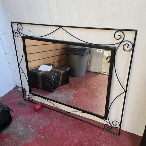 363 - An elegant large wrought metal mirror, featuring romantic scrollwork detail, ideal for a classic, so... 