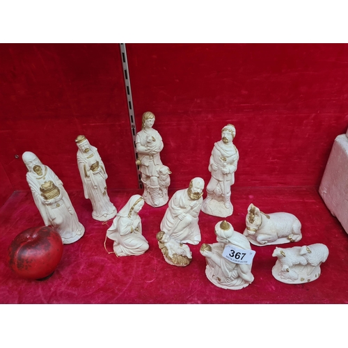 367 - A reverent nativity set, featuring timeless ivory-toned figures with golden accents, capturing the e... 