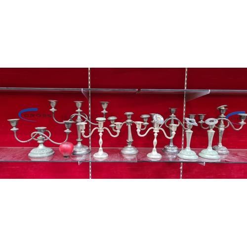 368 - A timeless collection of silver plated candlestick holders, offering a touch of classic elegance to ... 