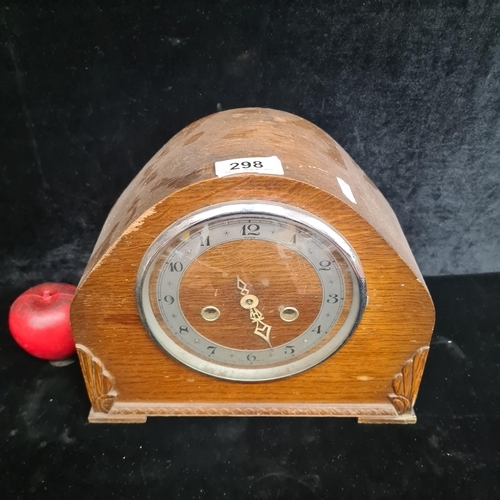 298 - A handsome vintage English made 8-day mantle clock housed in a wooden case with glass door and elega... 