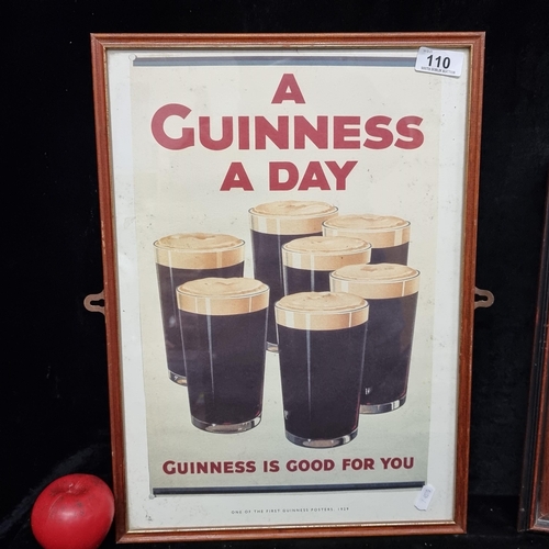 110 - A vintage print of a 1929 Guinness poster. Housed in a wooden frame behind glass.