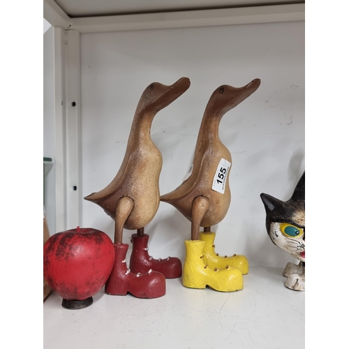 155 - A fabulous pair of whimsical hand carved wooden ducks with cast metal  painted wellingtons.