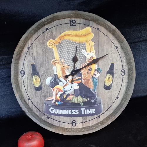 166 - A superb Guinness advertising clock in the form of a whiskey barrel top.