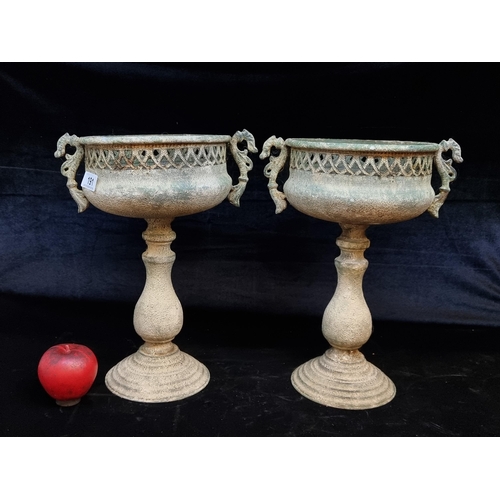 191 - A pair of charming metal pedestal planters featuring handles and pierced surrounds. H36cm