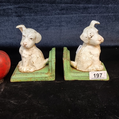 197 - A characterful pair of heavy cast metal book ends in the form of puppies.