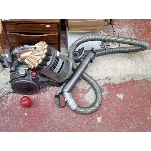 417 - A Dyson Stowaway DC23 Animal vacuum cleaner with large container, retrievable cable and attachment f... 