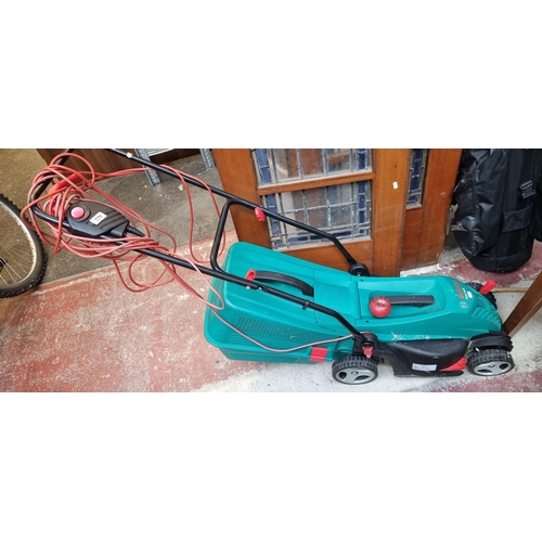 422 - A Bosch Rotak 34 R lawnmower with collection bin and cord. With RRP of €164 on diy.ie.