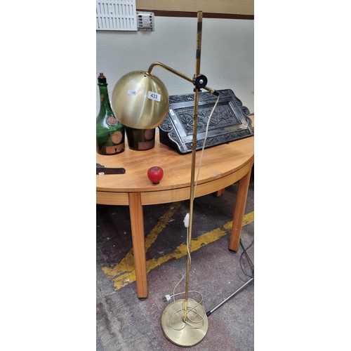 433 - A stylish brass floor standing lamp with a dome shade and adjustable height. Some wear to stem. H137... 