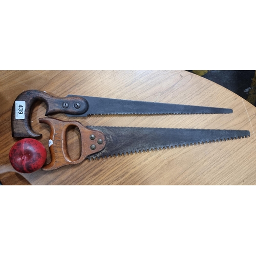 439 - Two vintage hand saws with wooden handles. In lovely condition.