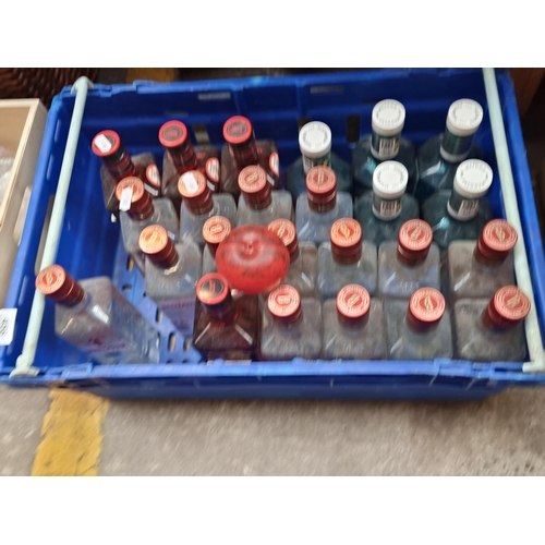 456 - A selection of 24 drummy alcohol bottles. Ideal for display.