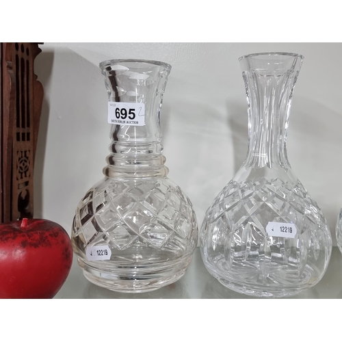 695 - Two elegant Waterford Crystal carafes including one in the Lismore pattern and a John Rocha example.... 