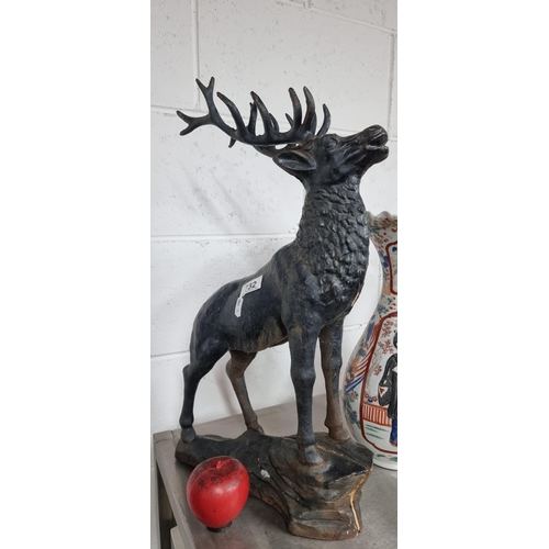 732 - A  large very heavy cast iron sculpture of a proud stag. H53cm