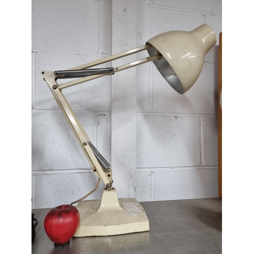 735 - A Mid Century Modern Anglepoise desk lamp designed by Herbert Terry & Sons Ltd. With a heavy base an... 