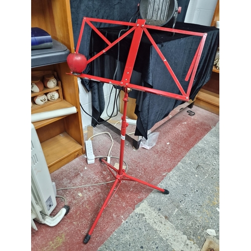 736 - A  good red folding metal music stand.