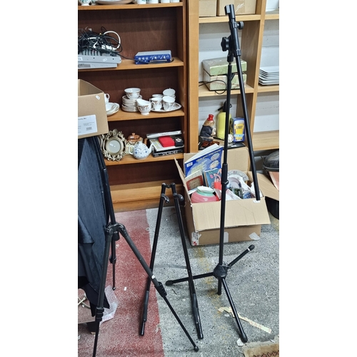 750 - A Mic stand, musical tripod stand base along with a guitar stand.