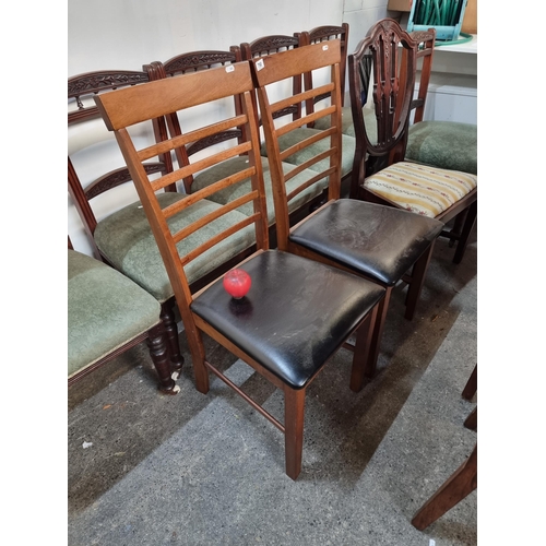 790 - A pair of stylish vintage ladderback dining chairs upholstered with a black leather seat.