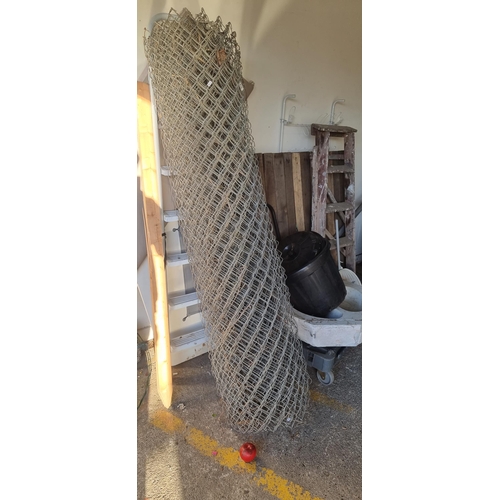 810 - A very large roll of metal net fencing. H180cm