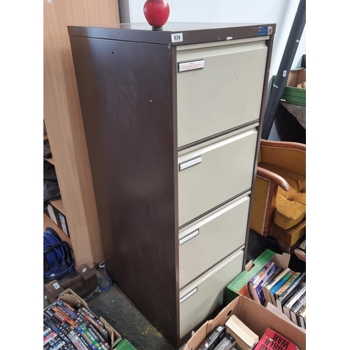 839 - A tall  metal filing cabinet with four deep drawers. No key but number on the lock so you can buy on... 