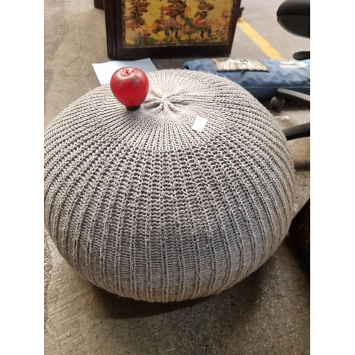 845 - A large pouffe footstool with a knitted grey fabric cover.