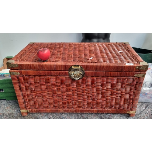 853 - A fabulous large wicker bed chest featuring brass reinforcements to corners, handles to sides with a... 