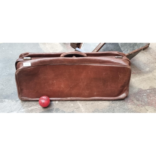 859 - A very long vintage leather bag featuring brass studs to base. In a stylish chestnut leather finish.... 