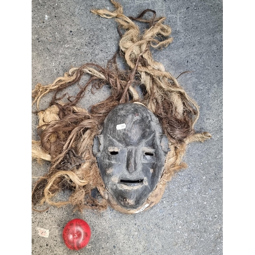 870 - Star lot : An African antique tribal Dan mask featuring rope weaving and dreadlock hair. The Dan Peo... 