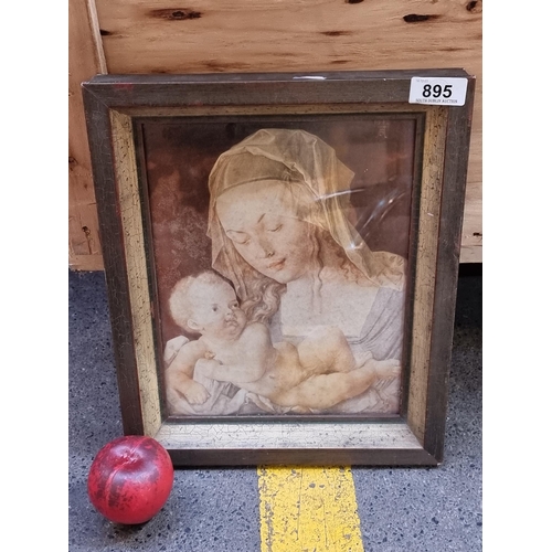 895 - A framed print of a painting showing the Madonna and Child in a tender pose. Housed in an antique gi... 