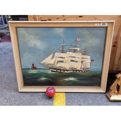 898 - An original oil on board painting dating to 1982 showing a tall ship out at sea. Rendered in fine de... 