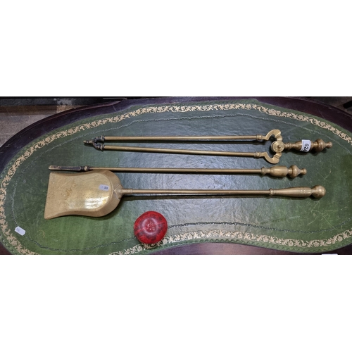 624 - A set of three antique solid brass fireside tools including poker, shovel and tongs.