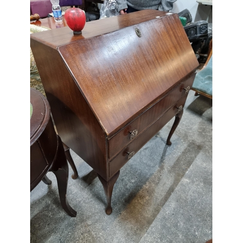 627 - A good 1950's writing desk with fold out writing slope, pigeon holes and two drawers with brass pull... 