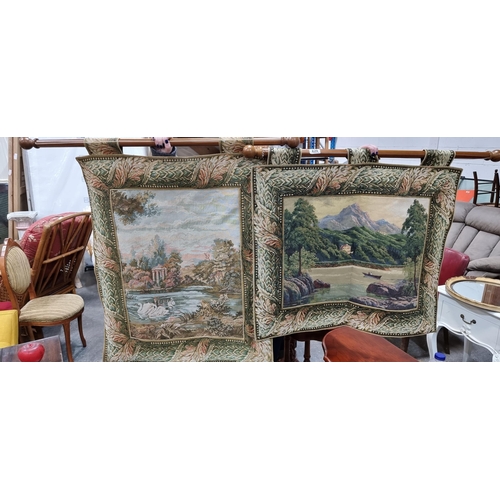 629 - Two vintage tapestry wall hangings featuring intricate lakeside landscape scenes with foliate border... 