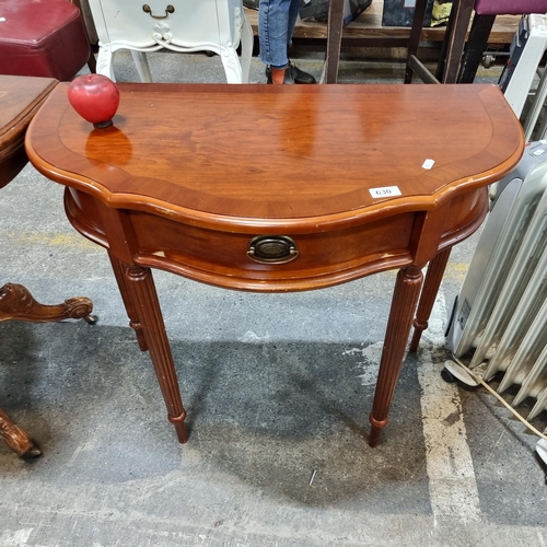 630 - A vintage flame mahogany console / hall table with carved reeded tapering legs and single drawer.