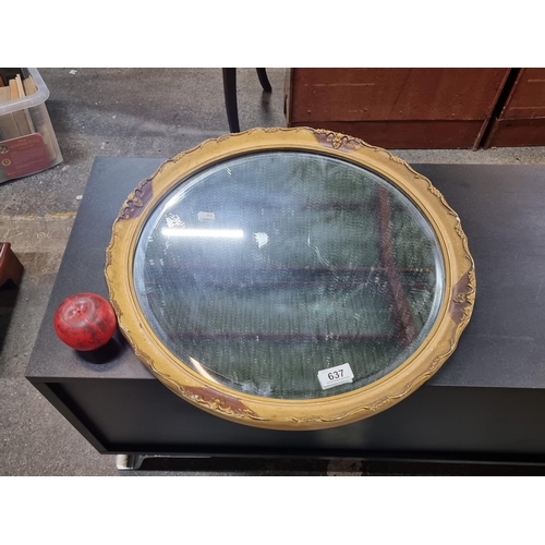 637 - A 1940's round molded gilt frame mirror with beveled glass.