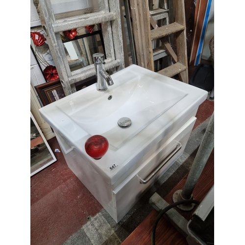 647 - A bathroom ceramic sink with vanity unit and chrome mixer tap and nice chrome towel rail to the fron... 