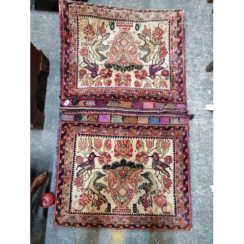 648 - A beautiful hand knotted wool rug / camel saddle bag. With pretty bird motif throughout in shades of... 