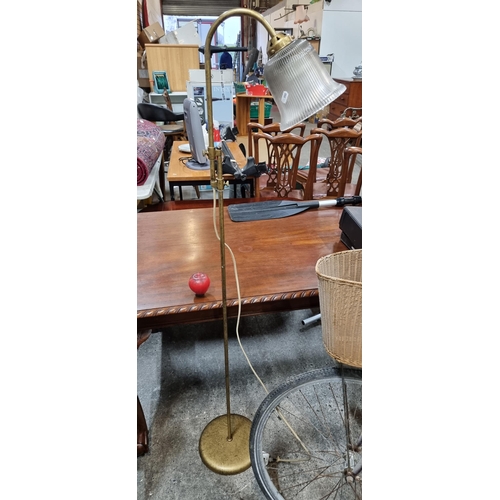 655 - A vintage brass and reeded glass floor reading lamp with adjustable height.