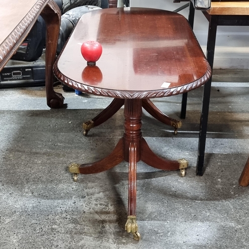 662 - A vintage mahogany double pedestal occasional / coffee table. Features carved edge and lion paw bras... 