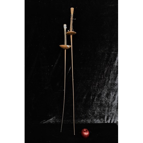 325 - Two vintage fencing foil swords with a wooden handles and metal blades, complete with a wire-wound g... 