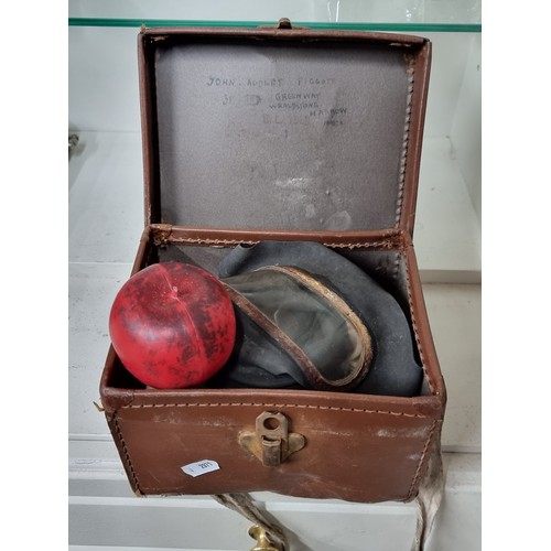 690 - An antique English gas mask housed in its original brown leather storage box.