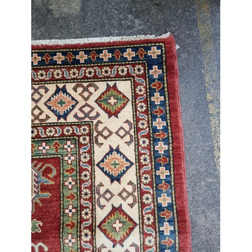 649 - Star Lot: An absolutely stunning large Kazakh hand knotted wool rug / carpet. With classic geometric... 