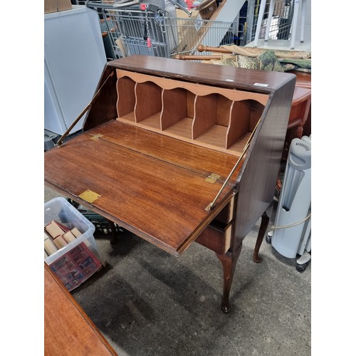 627 - A good 1950's writing desk with fold out writing slope, pigeon holes and two drawers with brass pull... 