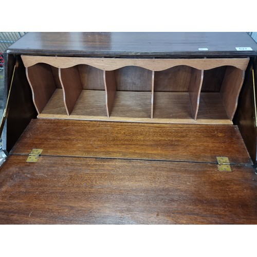 627 - A good 1950's writing desk with fold out writing slope, pigeon holes and two drawers with brass pull... 