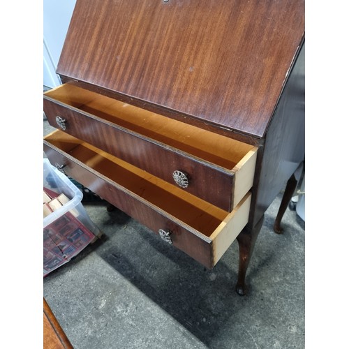 627 - A good 1950's writing desk with fold out writing slope, pigeon holes and two drawers with brass pull... 