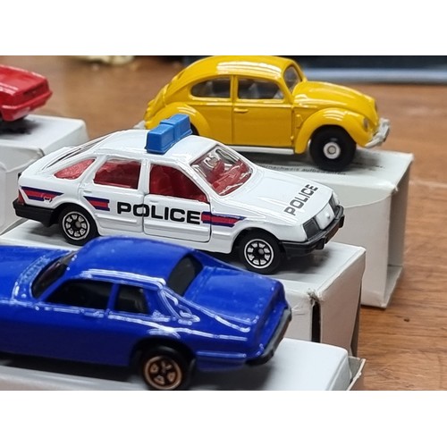 714 - A collection of nine boxed vintage Corgi model toy cars.